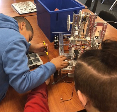在肯塔基州路易斯维尔的男孩和女孩避风港，学生们为FIRST技术挑战赛制作机器人。